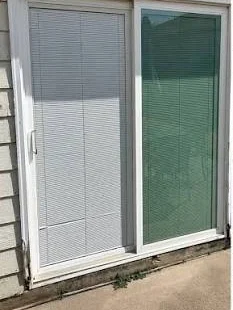 Before: Blinds-between-glass slider to a clear new door
